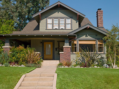 A house with grass and bushes around it.