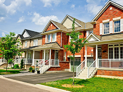 A row of houses with steps leading to the front.