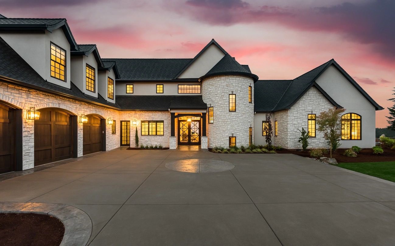 A large white house with a driveway in front of it.